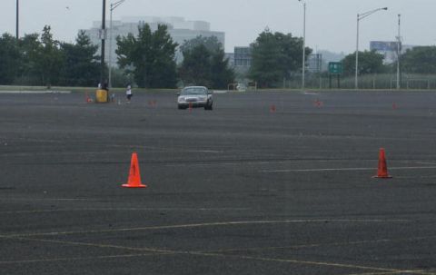 2001 Mercury Grand Marquis - A sedan navigates a course marked by orange cones on a cloudy day.