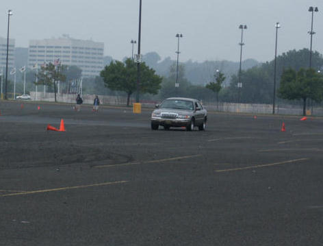 2001 Mercury Grand Marquis - A silver 2001 Mercury Grand Marquis navigates a course marked by orange cones on a hazy day.