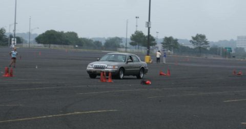 2001 Mercury Grand Marquis - A 2001 Mercury Grand Marquis navigates a cone course on a cloudy day.