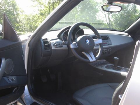 2003 BMW Z4 - The interior of a 2003 BMW Z4 is visible, the dashboard, steering wheel, and gear shifter.