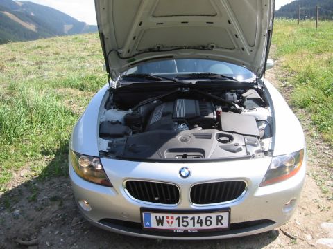 2003 BMW Z4 - Front view of a 2003 BMW Z4, hood open to reveal the engine bay. The license plate is visible.