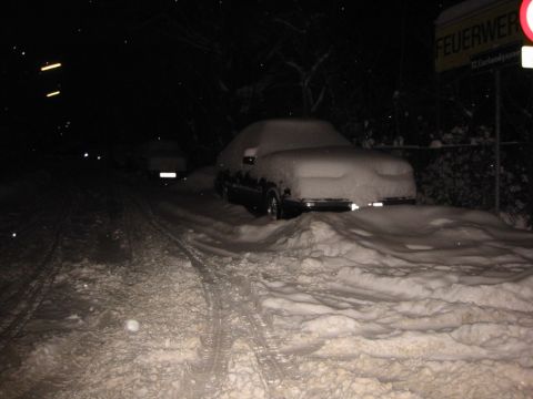 1992 Ford Crown Victoria - A snowy night scene shows two vehicles covered in deep snow, with a fire department sign visible.