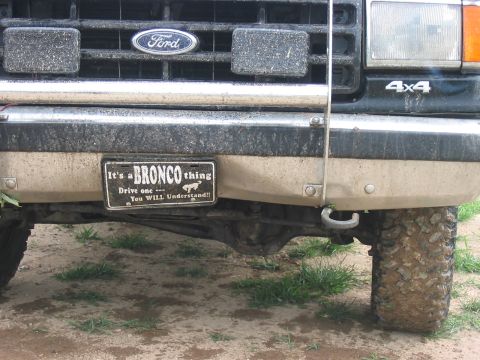 1988 Ford Bronco - A close-up of the front grille and bumper of a Ford Bronco, showing a custom license plate and '4x4' badging.