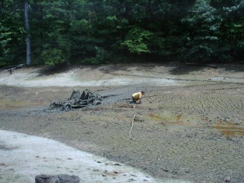 1993 Ford Bronco - A person attempts to free an off-road buggy that is stuck in thick mud.