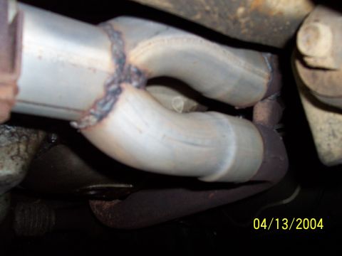 1994 Ford Bronco - Close-up view of a welded exhaust pipe, dated 04/13/2004.