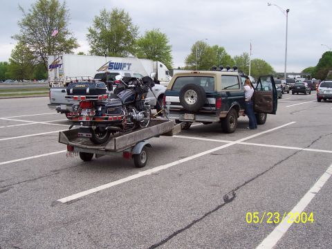 1994 Ford Bronco - Ford Bronco parked with a motorcycle loaded onto a trailer behind it.