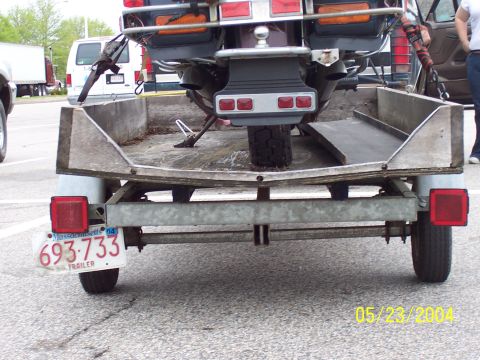1994 Ford Bronco - A motorcycle is secured to a trailer, viewed from the rear. The trailer has a Massachusetts license plate dated '04.