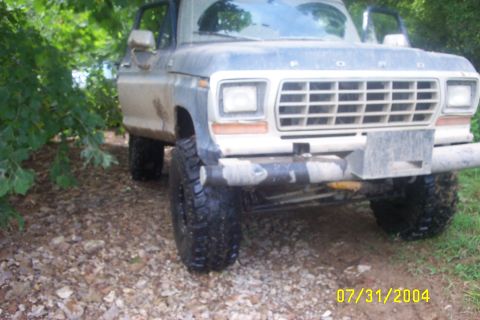 1979 Ford F-150 - Front view of a 1979 Ford F-150 truck with large tires, parked off-road.
