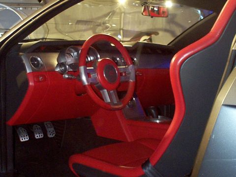 1999 Ford Taurus - Interior view of a car with red upholstery and a distinctive steering wheel design.