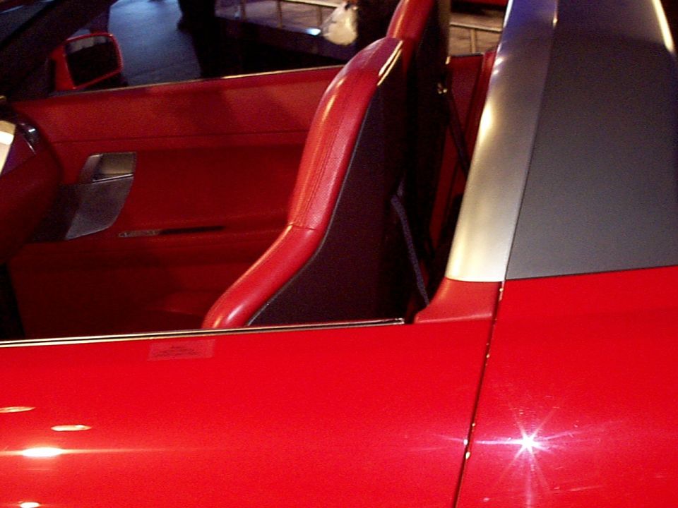 Red sports car interior with bucket seats and door panel