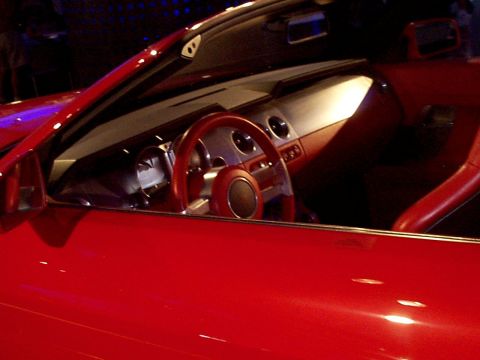 1999 Ford Taurus - Interior view of a red convertible, showing the dashboard and steering wheel.