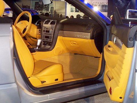 1999 Ford Taurus - Interior view of a convertible with bright yellow upholstery and a silver exterior.