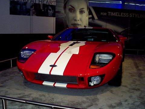1999 Ford Taurus - This red Ford GT features iconic white racing stripes and a prominent number '7' on its hood.