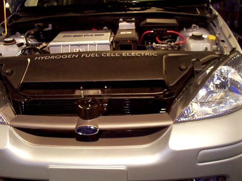 1999 Ford Taurus - The engine bay of a silver Ford Focus displays "HYDROGEN FUEL CELL ELECTRIC" text.