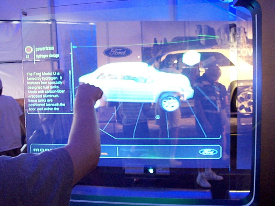 Photo of an auto-show interactive display screen showing a Ford Model U hydrogen concept