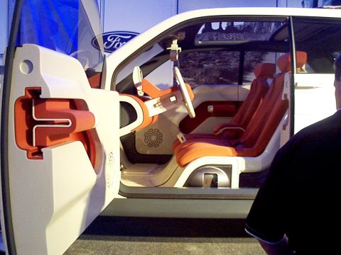 1999 Ford Taurus - The interior of a concept vehicle features unique orange seating and a futuristic dashboard design.