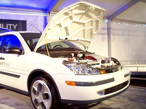 1999 Ford Taurus - This white vehicle has its hood open, revealing the engine bay.