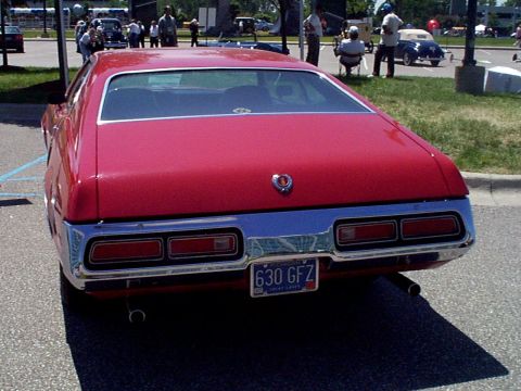1999 Ford Taurus - Rear view of a red car with a chrome bumper and dual taillights. The license plate reads 630 GFZ.