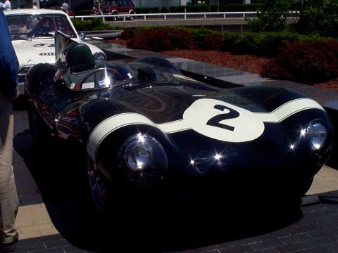 1999 Ford Taurus - A dark-colored vintage race car with white racing stripes and the number 2 is parked outdoors, with another vehicle visible behind it.