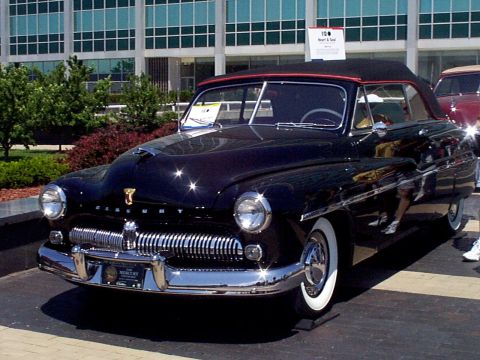 1999 Ford Taurus - A classic 1950 Mercury convertible is displayed outdoors, with a second vehicle visible in the background.