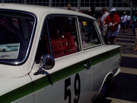 1999 Ford Taurus - A white sedan with a green racing stripe and the number 59 is seen from the side.
