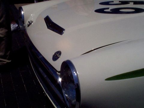 1999 Ford Taurus - Close-up of a white race car's front end, a green stripe and the number 59.