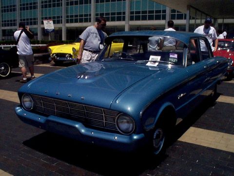 1999 Ford Taurus - A blue classic sedan is parked outside a building with other cars visible in the background.