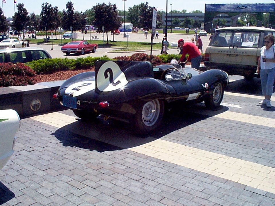 Black race car with white numbers 2 and 4, viewed from the rear