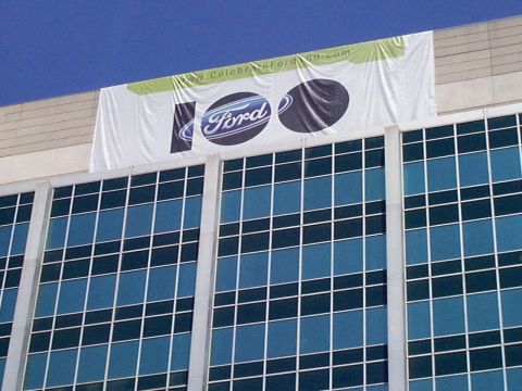 1999 Ford Taurus - Ford 100th anniversary banner displayed on a building facade.