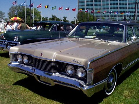 1999 Ford Taurus - A classic Mercury Colony Park station wagon with wood paneling is displayed on a grassy lawn.