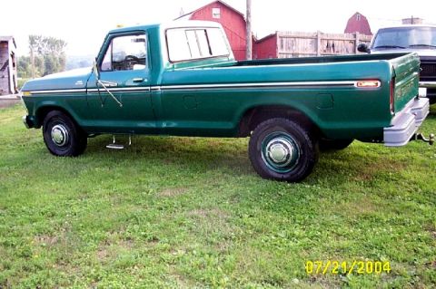 1973 Ford Ranchero - This green pickup truck is seen from the side, with a white cab. It appears to be a 1973 Ford F-Series truck.
