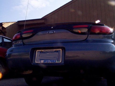 1999 Ford Taurus - Rear view of a dark blue 1999 Ford Taurus, showing its taillights and license plate.