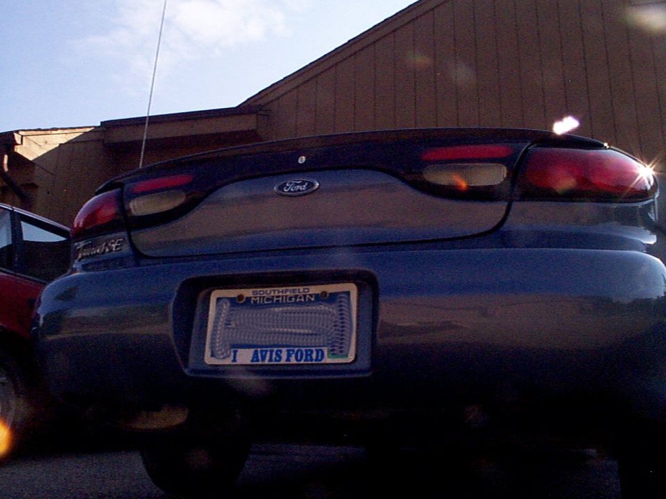 Dark blue 1999 Ford Taurus rear with Michigan license plate