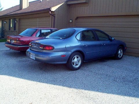 1999 Ford Taurus - 99SE parked next to our non running 90 Tempo GL 2.3L HSC atx