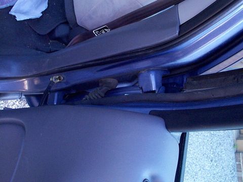 1999 Ford Taurus - Close-up view of the interior door frame and wiring harness of a blue 1999 Ford Taurus, with a Supermotors.net watermark.