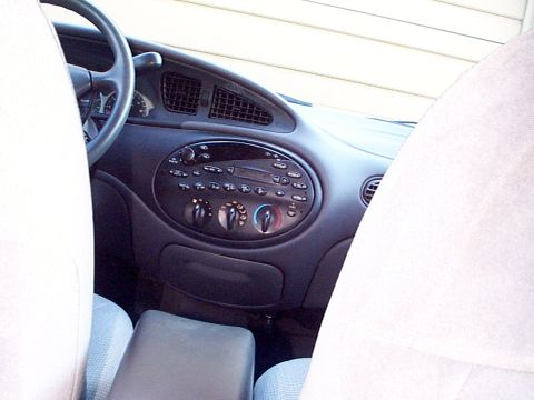1999 Ford Taurus - The interior of a car is visible, focusing on the dashboard and controls.