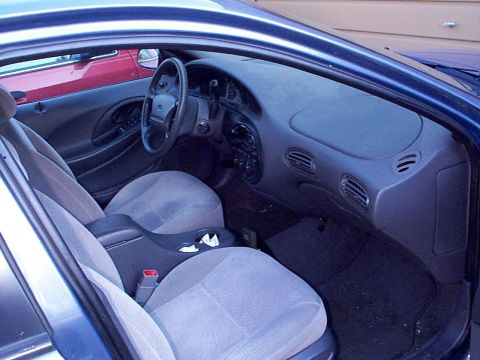 1999 Ford Taurus - Interior view of a 1999 Ford Taurus SE, highlighting the dashboard and seating.