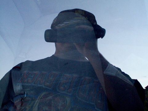 1999 Ford Taurus - A person's reflection is visible through a window, obscuring the view of the exterior.