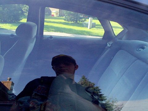 1999 Ford Taurus - Rear interior view of a 1999 Ford Taurus, with a person visible in the reflection.