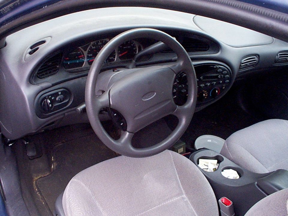 1999 Ford Taurus interior showing dashboard, steering wheel, and front seats