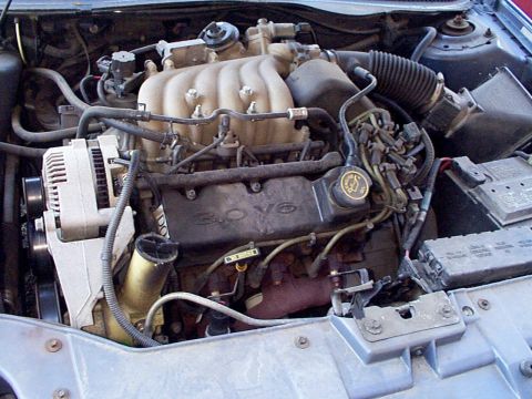 1999 Ford Taurus - The engine bay of a 1999 Ford Taurus, clearly showing the 3.0 V6 engine configuration.