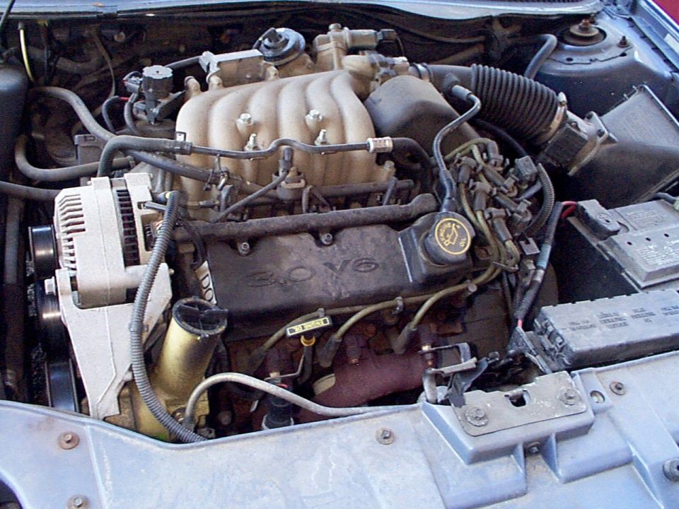 1999 Ford Taurus engine bay with 3.0 V6 badge visible