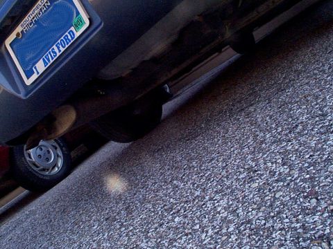 1999 Ford Taurus - The rear of a 1999 Ford Taurus is visible, showing the bumper and license plate.