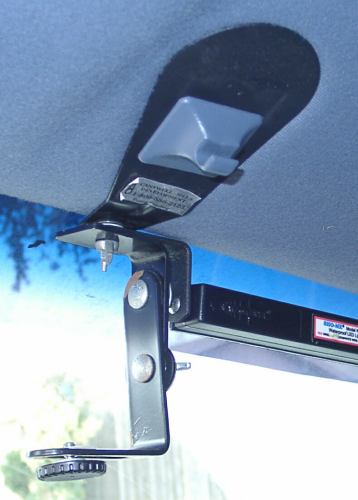 2001 Ford Crown Victoria - A close-up view of an aftermarket light bar mount attached to the vehicle's headliner.