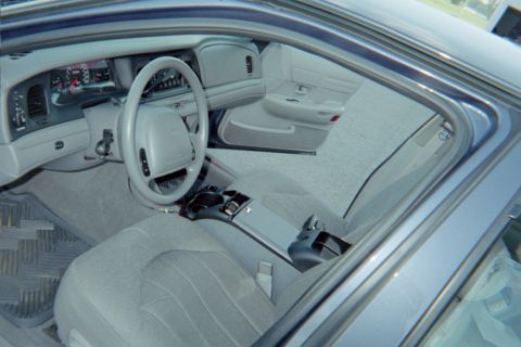 1998 Ford Crown Victoria - Interior view of a 1998 Ford Crown Victoria, highlighting the dashboard and seating area.