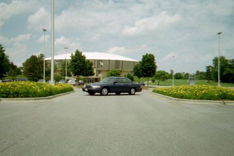 1998 Ford Crown Victoria - Dark blue 1998 Ford Crown Victoria in a parking lot with a large building and landscaping.