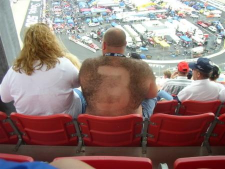 1993 Ford Bronco - Spectators watch a race from stadium seating overlooking the track and pit area.