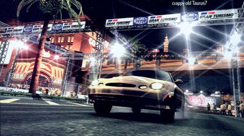 1999 Ford Taurus - Video game screenshot from Gran Turismo showing a tan Ford Taurus sedan launching from a night-lit Las Vegas street start line, under gantr…