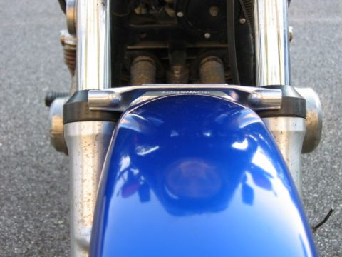 1985 Ford Crown Victoria LTD - Close-up view of a blue motorcycle's front fender and suspension system.