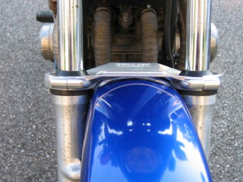 1985 Ford Crown Victoria LTD - Front view of a blue motorcycle, showing the fender, chrome suspension components, and a brace with 'DAYTONA' visible.